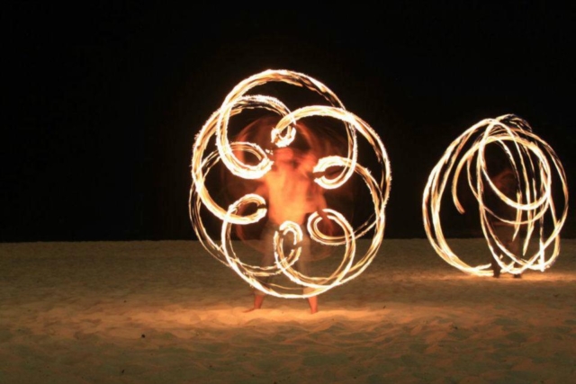 Duncan Greenwood practicing in-spin flower patterns with fire flower sticks - slow shutter photography. - Flow DNA